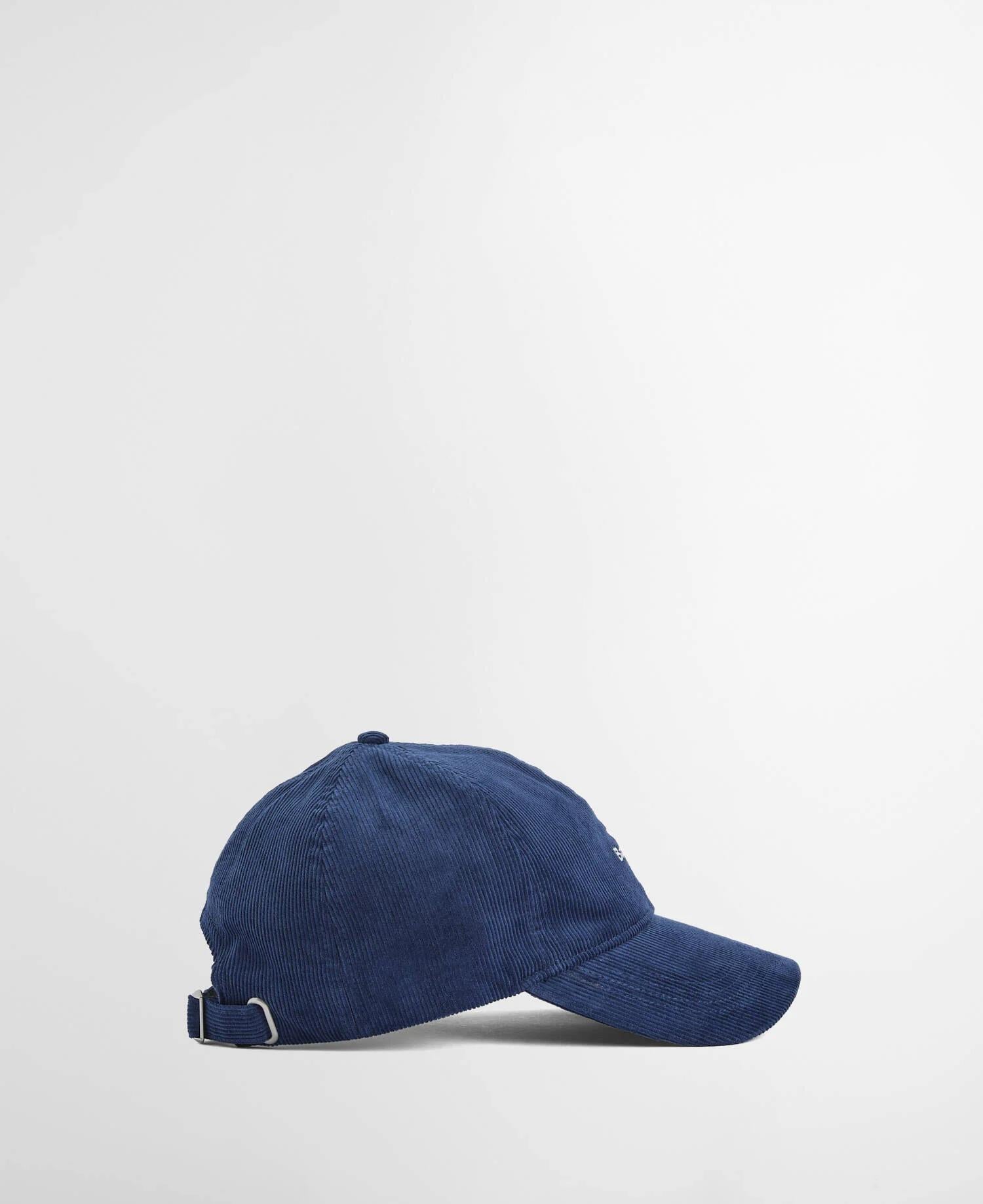 Marineblå kordfløyel caps fra siden. Viser capsen med buet brem, formen og klassisk seks-panel design.